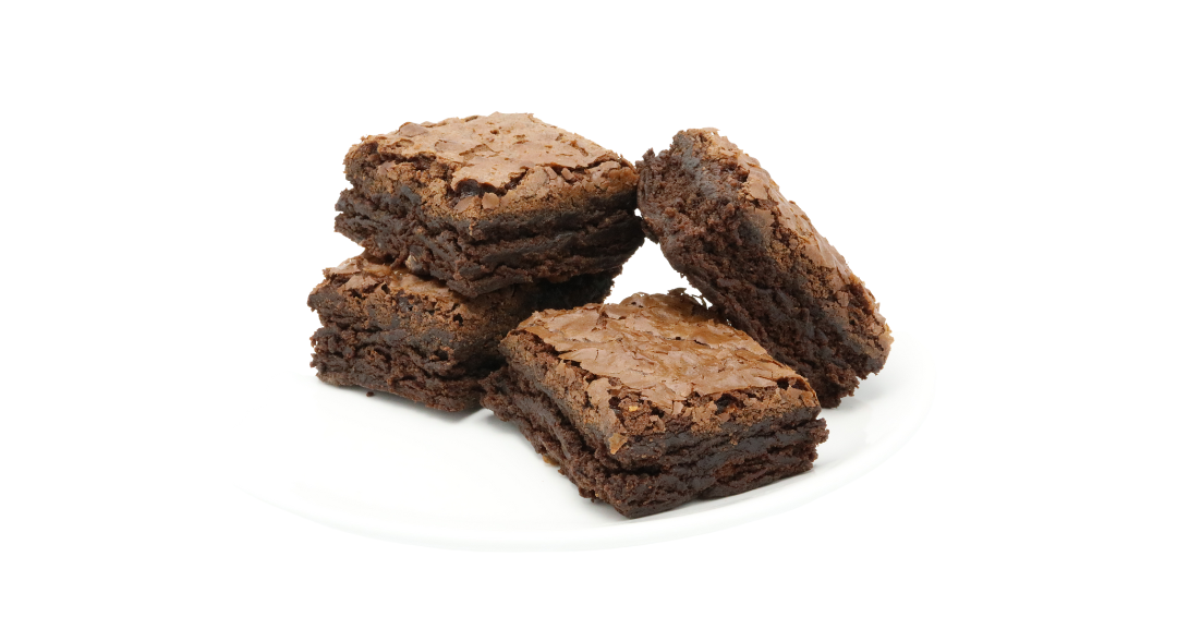 Stack of four brownies on white plate