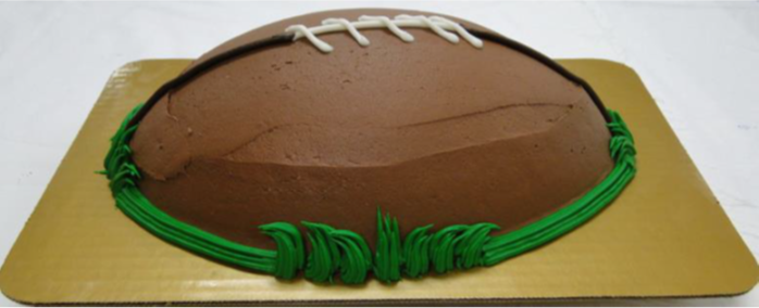 Football shaped cake with green icing border