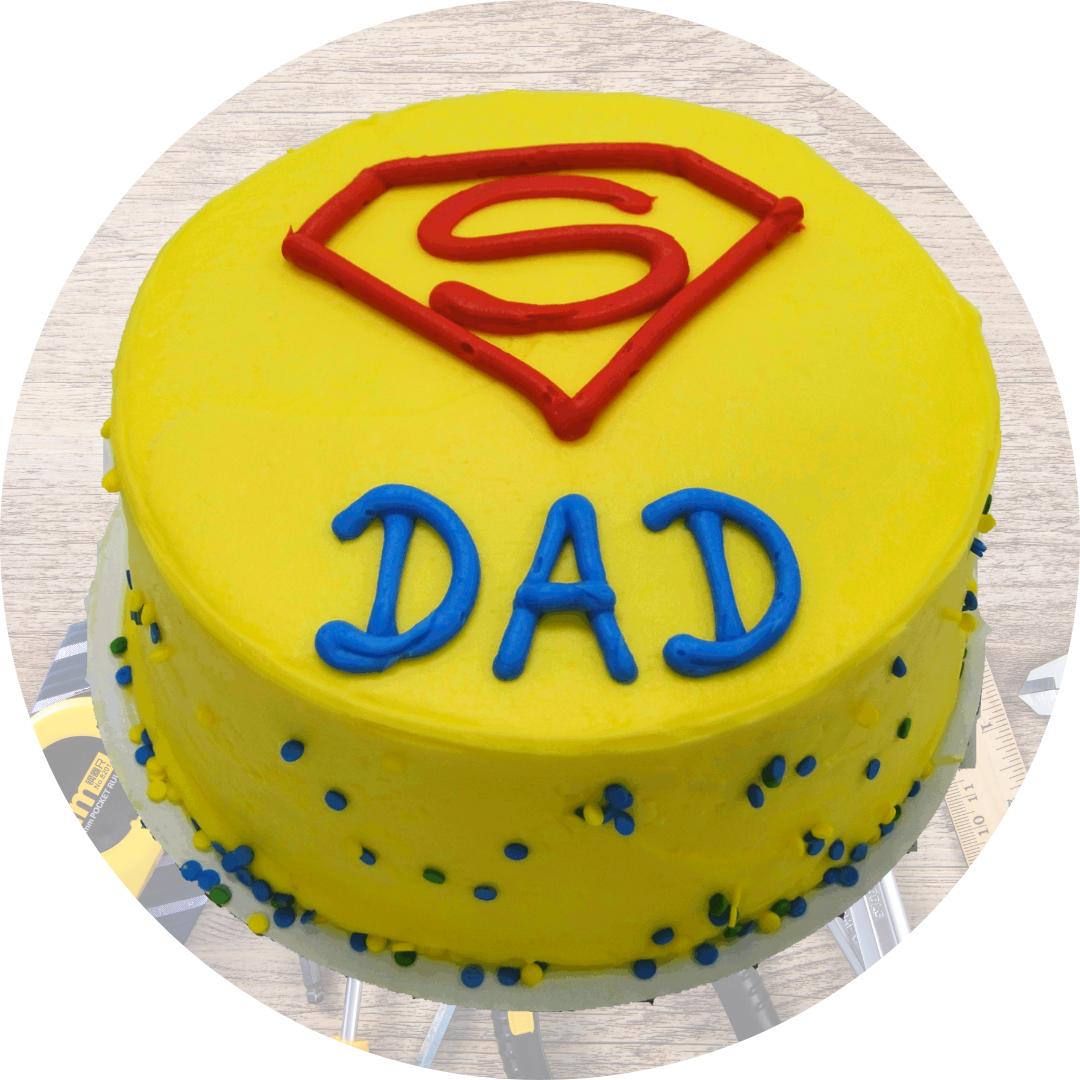 Yellow cake with "DAD" and Superman symbol