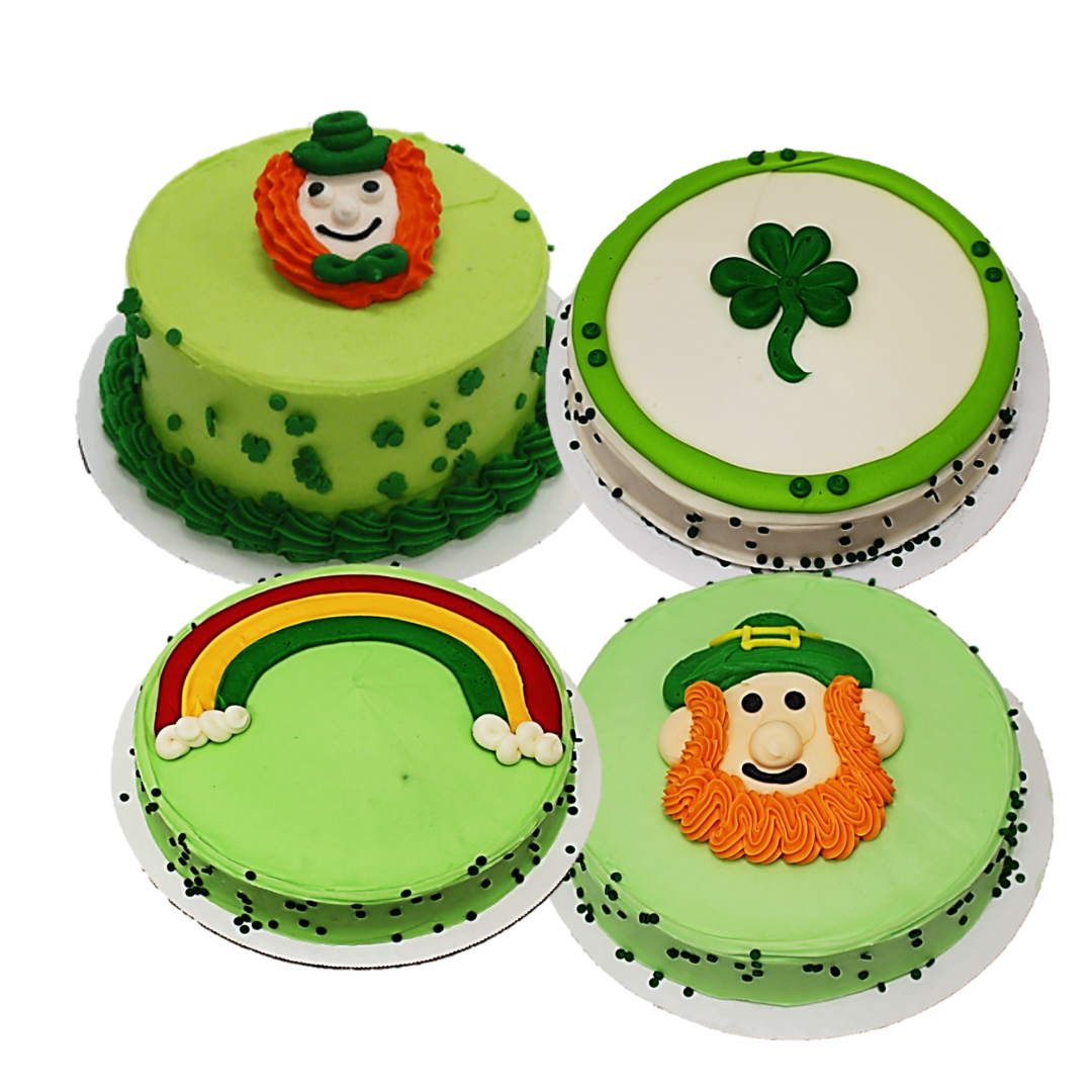 Four St. Patrick's themed cakes with shamrocks, rainbows, and other thematic elements